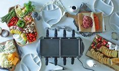 a table topped with plates and utensils filled with different types of food next to each other