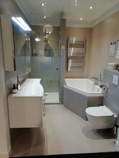 a bathroom with a toilet, sink and bathtub next to a walk in shower