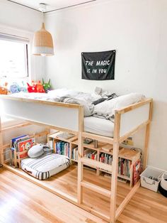 there is a loft bed in the middle of this room with bookshelves on both sides