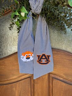 the front door is decorated with an orange and white scarf