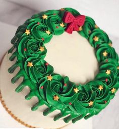 a cake decorated with green icing and gold stars