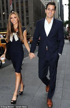 a man and woman holding hands walking down the street in new york city, ny