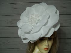 "Gorgeous white felt rose flower fascinator, layers of white felt with a pretty white center.  This flower is about 12\" wide. Each one is handmade by me so there may be a small difference in size. The felt is not floppy, the petals stay in place. What is nice about this felt flower is you have control over how fluffy you want it. Just gently pull the edge of the petals up and they will stay in place or give it a shake and it fluffs up nice.  DO NOT get it wet,...it is felt. The base is white and comes with a satin covered plastic headband. This white rose is approx. 12\" wide, Lightweight and easy to wear. You can wear it on either side of your head. NOW Please read Will this felt flower fascinator look exactly on you as it does on my mannequin? I don't know. I position the fascinator on White Flower Hats For Party, White Fascinator With Handmade Flowers For Royal Ascot, White Handmade Flower Fascinator For Kentucky Derby, White Hats With Handmade Flowers For Royal Ascot, White Handmade Flowers Fascinator For Royal Ascot, Fitted White Flower Hats, White Fitted Flower Hats, White Flower Fascinator For Spring, Elegant White Flower Mini Hat