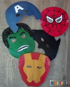 four paper plates with different masks on them