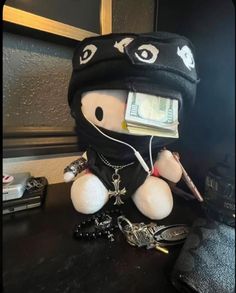 a stuffed animal wearing a hat with money attached to it