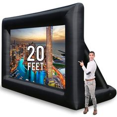 a man standing next to an inflatable screen with the number 16 feet on it