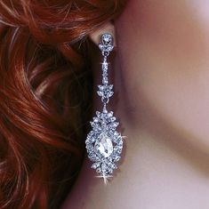 a close up of a woman's head wearing earrings