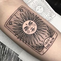 a sun and moon tattoo on the arm