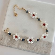 EXCLUSIVE OFFER Save 25% when you by 2 items PRODUCT Enhance your daring style with our flower beaded bracelet! Crafted with mother of pearl, tiger eye, red onyx, and 14K gold filled beads, this bracelet is inspired by the delicate daisy in a secret garden. Make a statement and add a touch of adventure to your look! 😉 LENGTH 6.5 inches with 1.5 inches extender SHIPPING Enjoy free shipping on ALL orders within the US. Shop now and take advantage of our convenient shipping options. Shop now and e Flower Beaded Bracelet, Diy Bracelets With String, Jeweled Bag, Making Bracelets With Beads, Gold Beaded Bracelet, Diy Beaded Bracelets, A Secret Garden, Gelang Manik-manik, Diy Jewelry Unique