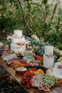 a table topped with lots of different types of cakes and desserts on top of it