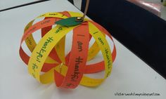 an ornament made out of strips of paper with words written on the sides