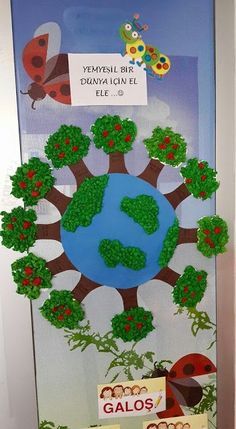 the door is decorated with an earth globe and trees, which are surrounded by butterflies