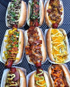 six hot dogs with different toppings on them