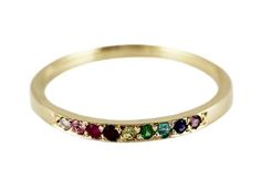 a yellow gold band with multi colored stones