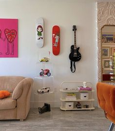 a living room filled with furniture and guitars on the wall