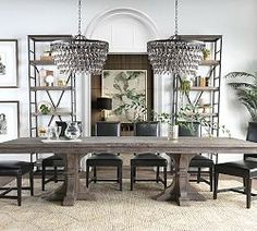 a dining room table with chairs and chandelier