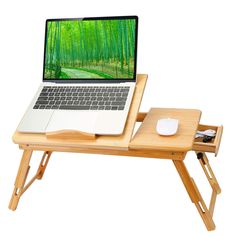 a laptop computer sitting on top of a wooden desk