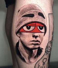 a man's leg with a tattoo on it and an image of a person wearing a beanie