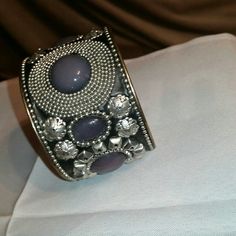 Splurge Silver, Black, Purple Cuff Bracelet. This Cuff Bracelet Is Very Pretty Complete With 8 Resin Purple Stones With So Much Silver Design Work On A Black Background That Looks Like Leather. So Very Cool, This Slip On Cuff Is '2&3/4' Circumference, '1&3/4' Inch In Width & Very Pretty With All The Artwork. Jean Jacket Ready! (See All Pics!) New Condition. Tag On Inside Of Bracelet. So Very Cool! Silver Bohemian Metal Cuff Bracelet, Silver Metal Bohemian Cuff Bracelet, Bohemian Silver Metal Cuff Bracelet, Adjustable Silver Cuff Bracelet For Party, Purple Metal Bracelet For Party, Purple Metal Bracelets For Party, Adjustable Silver Cuff Bracelet For Festival, Adjustable Silver Bangle For Party, Silver Bohemian Cuff Bracelet For Party