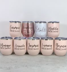 six bridesmaid wine tumbles with names on them in pink, white and silver