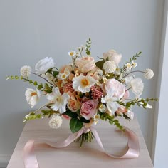 a bouquet of flowers sitting on top of a wooden table