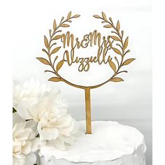 a cake topper with the words mr and mrs on it next to some flowers