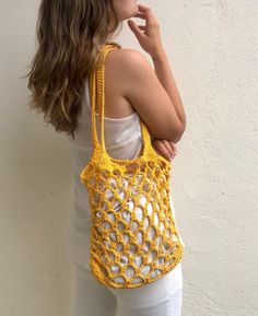 Crochet market bag handmade in a bright yellow color, perfect for summer with long and strong straps, perfect for beach days or to give an extra touch to your summer outfits. This net shoulder bag is handmade in 100% cotton, every bag is made to order, giving an extra attention to the details what makes the pice unique and timeless. Designed to be as special as her new owner. The bag includes a cotton pouch so you can keep your belongings safe! WHICH IS THE BAG SIZE? Check of the bag fits your p Yellow Crochet Beach Bag, Summer Crochet Bag For Shopping, Hand Knitted Tote Shoulder Bag For Summer, Summer Hand Knitted Tote Shoulder Bag, Yellow Crochet Tote Bag For Summer, Summer Hand-knitted Tote Shoulder Bag, Summer Crochet Bag Hand Knitted For Shopping, Yellow Crochet Bag For Summer, Yellow Crochet Shoulder Bag For Vacation