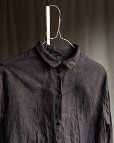 M size, fits chest under 96cm ---------------- Untrue black linen shirt TWILIGHT This shirt is made of natural high-quality medium weight linen. Each shirt is over dyed with natural tannin extracts and iron to achieve greyish black shades, slightly imperfect. Shirt has button closure, tailed hem, small collar which is possible to turn up and down, wide cuffs with two buttons on each. Collar and cuffs are hand stitched with natural linen thread. Buttons are made of hand dyed coconut. Total length ~70cm (front, shorter at the sides). All the materials are prewashed to avoid shrinkage. Black Linen Button Shirt, Black Linen Tops For Workwear, Black Linen Top For Workwear, Black Collared Linen Shirt, Black Linen Collared Shirt, Black Linen Long Sleeve Top, Black Linen Blouse For Work, Fall Linen Tops With Natural Dye, Thread Buttons