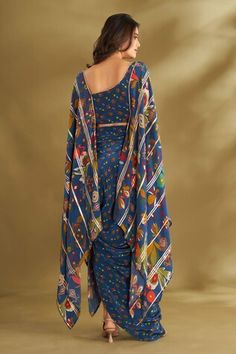 Blue cape blouse with floral, ikat print and gota embroidered panel. Paired with printed draped skirt. - Aza Fashions Blue Draped Blouse Piece, Floral Cape, Cape Blouse, Blue Cape, Women Skirt, Draped Skirt, Cape Sleeves, Ikat Print, Skirt Sets