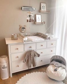 a baby's room with a crib and dresser