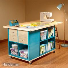 a sewing machine sitting on top of a wooden table next to a lamp and bookshelf