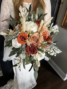 a woman holding a bouquet of flowers in her hands