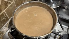 a pot on top of a stove filled with liquid