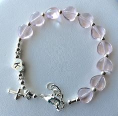 "This Beautiful Bracelet  is one-of-a-kind. This beautiful Rosary Bracelet features with Rosaline Czech Pressed Glass Hearts (8mm), Sterling silver beads, and finish with sterling silver clasp. This bracelet is approximately 6\" in length. The bracelet also includes a one inch  extender \"grow chain\". The Sterling silver beaded cross is  15mmx11mm.   Your bracelet grow up to 7\" inches.  All Parts are sterling silver. Simple, Stylish, Elegant Rosaline is a very pale rose color. Thanks for looki Confirmation Jewelry, Bracelet Rosary, Real Pearl Bracelet, Baby Jewellery, Beautiful Rosary, Teardrop Pearl Earrings, Flower Girl Bracelets, Glass Hearts