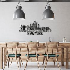 a dining room table with four chairs and a wall sticker that says new york