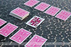 pink playing cards laid out on the ground