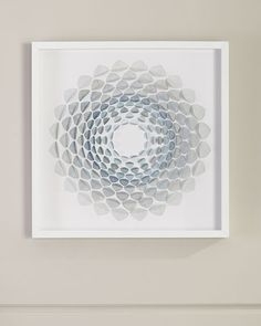 a white framed artwork hanging on the wall