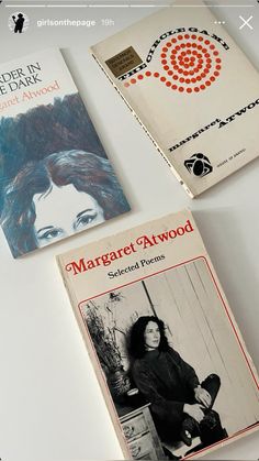 three books sitting on top of a white table next to each other and one has an image of a woman's face