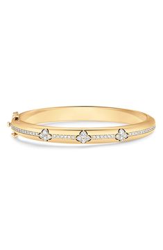 Sparkling pavé diamonds illuminate a sleek bangle bracelet crafted from high-shine 18-karat yellow gold. 6 1/2" inner circumference Push-clasp closure Total diamond weight: 1.06ct. Color: G–H Clarity: VS–SI 18k gold/diamond Imported >Diamond Guide Timeless Yellow Gold Bangle With Pave Setting, Classic Gold Bangle Bracelet With Pave Setting, Classic Yellow Gold Bangle With Pave Setting, Diamond Bangle Bracelet, Diamond Bangles Bracelet, Diamond Guide, Diamond Bangle, Bracelet Gold, G H