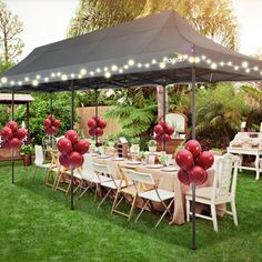 an outdoor dining area with tables and chairs set up for a party under a canopy