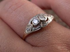 "WE SELL THIS NICE AND ANTIQUE RING MADE IN 18K GOLD,and platinum finished setting, DECORATED with 2 central genuine diamond 0.08ctw + 4 little genuine rose cut diamonds, IN VERY GOOD CONDITION , , PLEASE SEE THE PICTURES AND TAKE THEM AS A PART OF THE ITEM DESCRIPTION MEASURES HEAD 5/8\" x 5/16\" SIZE 7 3/4 WEIGHT 1.9gr if you need resize only request for free after buy As is a vintage antique item , it's unique , for that if you like to wear it , don't miss the opportunity, we gladly offer MIC Antique Diamond Ring With Bezel Setting, Antique Single Cut Diamond Ring Gift, Victorian Diamond Ring With Accents For Gift, Antique Diamond Ring With Single Cut Diamonds For Gift, Antique Diamond Ring With Single Cut Diamonds As Gift, Victorian Diamond Ring With Accents For Anniversary, Antique Rose Cut Diamond Ring For Anniversary, Antique Diamond Ring With Rose Cut For Anniversary, Antique Diamond Ring With Rose Cut Diamonds For Anniversary