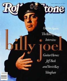 the cover of rolling stone magazine featuring billy joel, wearing a hat and holding his hands