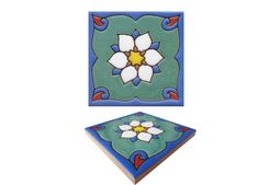 two pieces of art that are in the shape of flowers on a white background and one is blue