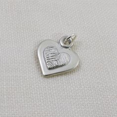 Keep your loved one with you always, with this stunning fingerprint pendant that combines elegance and sentimentality.  The raised fingerprint accentuates its importance and draws attention to the beautiful details of the print. The irregular edges and shiny finish of the pendant give it a custom touch, making it suitable for any occasion, whether casual or formal. Fingerprint Pendant, Pendant Heart