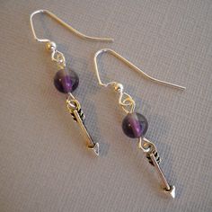 Lightweight Beaded Handcrafted Dangle Pierced Earrings. Purple Amethyst Semi-Precious Stone Beads. Silver Metal Arrows & Hooks. Approx. 1 1/8" Long. New With Tag. Purple Sterling Silver Beaded Dangle Earrings, Adjustable Pierced Silver-plated Jewelry, Adjustable Pierced Silver Plated Wire Jewelry, Purple Beaded Sterling Silver Jewelry, Nickel-free Purple Sterling Silver Beaded Earrings, Amethyst Drop Earrings With Dangling Beads, Clover Charm, Handmade Earrings Beaded, Earrings Purple