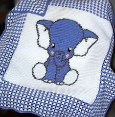 a blue and white hat with an elephant on it