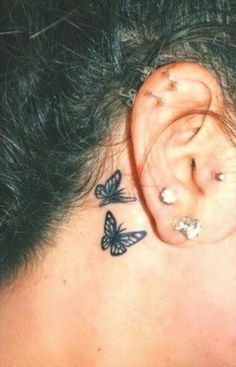 a woman's ear with butterflies on it