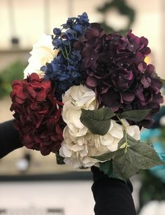 a person holding a bouquet of flowers in their hands