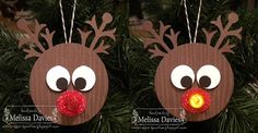 two reindeer ornament hanging from a christmas tree with red nose and antlers