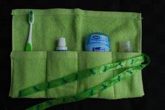 a green towel with toothpaste, mouthwash and lotion on it